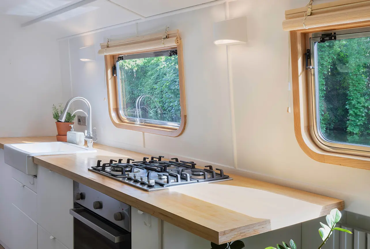 2house boat interior design london 05 galley kitchen hob window