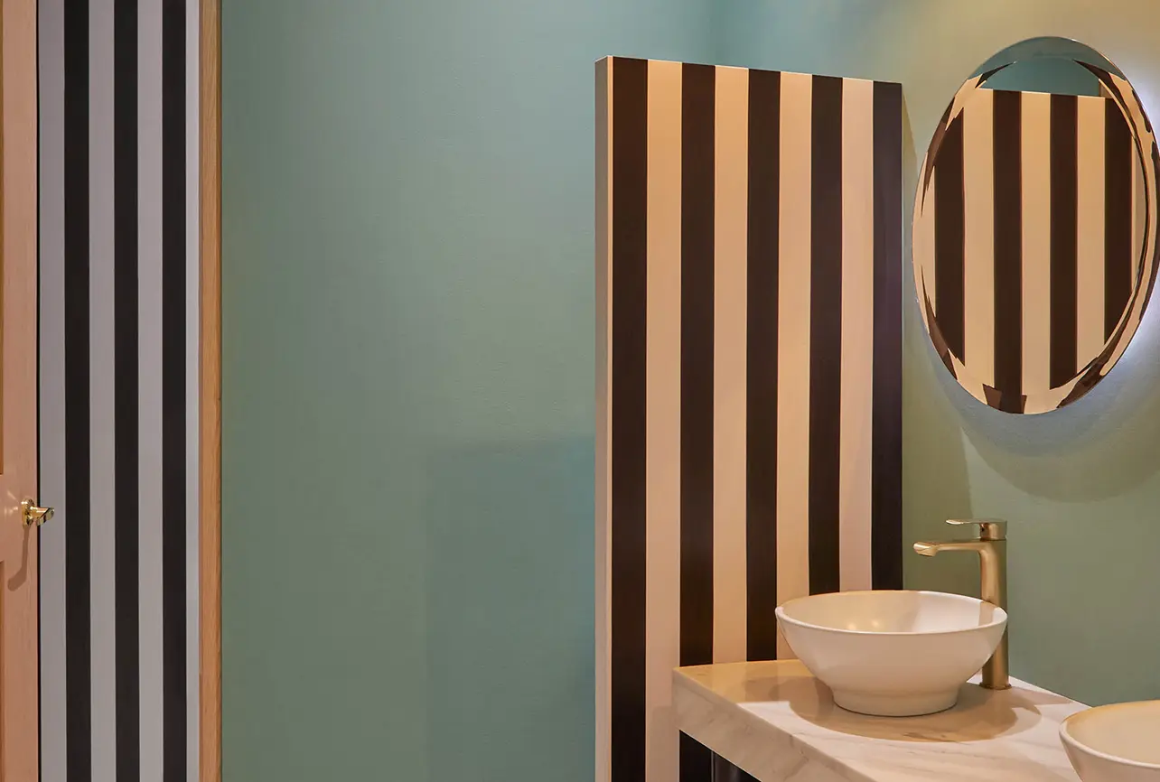 italian restaurant washroom interior design london sage green striped panel vessel sink