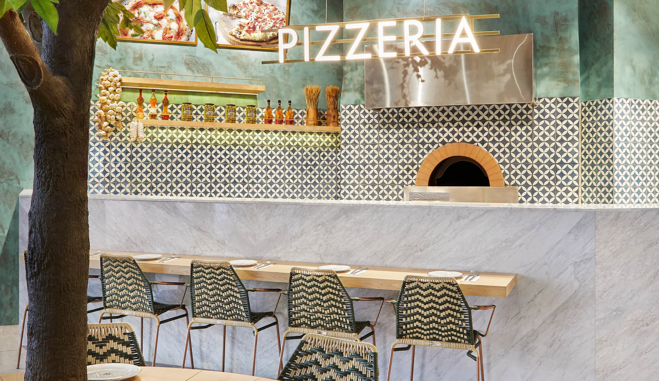 pizzeria interior design london wood fired oven tiled counter tree table
